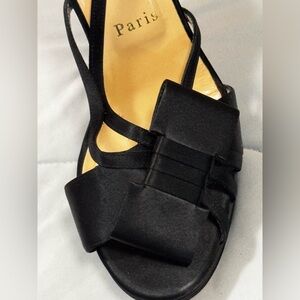 Christian Louboutin, 140 black satin bow platform heels.